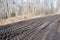 spring landscape with muddy swamp, forest road, spring, dirty wet road texture