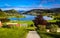 Spring Landscape with Overview of A Tranquil Valley with Green Meadows, A Heart-shaped Lake and Farm Houses in The Sunlight