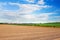 Spring of landscape with ploughed field and blue sky