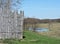 Spring landscape with pond, wooden fence and trees in april