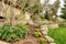 Spring Landscape with retaining walls and garage.