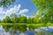 Spring landscape river clouds blue sky green trees