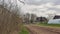 Spring landscape. Rural house building and small greenhouse