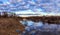 Spring landscape, sky, clouds, temple on the bank of the river flooded