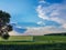 Spring landscape trees cloudy sky path grass green and blue color