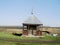 Spring landscape with wooden chapel in the field