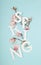 Spring letters with white and pink magnolia tree flowers and branches against pastel blue background. Minimal vertical nature