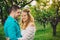 Spring love couple hugging and kissing in cherry wood at sunset