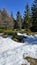 Spring melting snow in the mountains on sunny meadows. Scenery