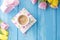 Spring morning, fragrant coffee and tulips of yellow and pink color. Donuttsy copies. Blue wooden background, place for text and