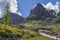 Spring in the mountains. Snow on the mountainside, the first green