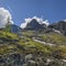 Spring in the mountains. Snow on the mountainside, the first green