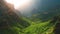 Spring nature with bright green grass and trees on a sunny morning. The rays of the sun shine Masca Gorge and village in