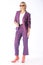 Spring outfit, portrait of a modern young blonde woman in a purple lilac pantsuit and boots with heels, shot on a white background