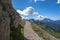 Spring panorama of the green meadows of the Dolomites with snow and pink rocks at the Falzarego pass in Cortina d`Ampezzo Belluno