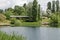 Spring panorama of a part of residential district, bridge and Thermoelectric power plant neighborhood along a lake with green tree