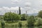 Spring panorama of a part of residential district and Thermoelectric power plant neighborhood along a lake with green trees, shrub