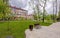 Spring park with stone walkways and benches Moscow on a spring day with clouds.