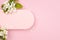 Spring pink blank rounded horizontal pad for text mockup with gentle white apple tree flowers, green leaf on pastel pink.