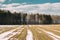 Spring Plowed Field Partly Covered Winter Melting Snow Ready For New Season. Ploughed Field In Early Spring. Farm