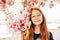 Spring portrait of adorable red-haired preteen kid girl with magnolia flowers