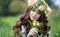 Spring portrait of a beautiful woman in a wreath of flowers