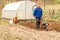 Spring preparation soil for seeding with tiller. Spring work in the garden. Farmer plows the land with a cultivator, preparing it