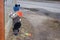 Spring in a provincial town, the baby walks and rolls a typewriter on a string