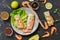 Spring rolls with shrimps on a dark concrete background. Asian food. Top view, flat lay