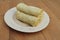 Spring rolls on a white ceramic plate