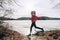 Spring running girl training outside jogging by the lake in nature countryside. Woman athlete runner exercising cardio