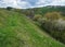 Spring rural hills landscape with terrace fields, farm flowering trees, hilly meadows. Sutkivtsi village, Khmelnytsky region,