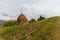 Spring rural landscape with a haystack