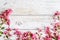 Spring Rustic background with pink flowers. Copy space on white wood. Valentine day internet sales concept, online shopping