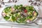 Spring salad with radishes and broccoli and kale microgreens on a white background