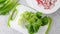 Spring salad recipe. Mixing lettuce, spinach, and radish. Close-up preparation process, recipe