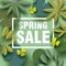 Spring sale card with different floral elements in shades of green.