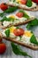 Spring sandwiches with cheese, eggs, tomatoes and rucola