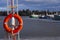 A spring scene of a small leisure boat harbor with orange lifesaver in the foreground