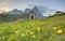 Spring scenery of Dolomites with view of a lovely church at the foothills of rugged mountain peaks