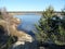 Spring shore of Bay in forest with remains of melting ice floes on Sunny day