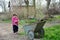 In the spring of small rural girl carries a wheelbarrow.