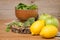 Spring spinach leaves in the bowl, broccoli, lemons and apples