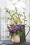 Spring still life with bouquet of corydalis flowers and willow in bloom