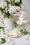 spring still life with a bouquet of white lilacs, a stack of waffle ice cream in a bowl and on a saucer