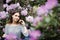 Spring, summer, beauty, healthcare. Beautiful woman among purple flowers outdoors