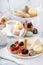 Spring or summer dessert table, three tiered tray with desserts