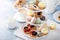Spring or summer dessert table, three tiered tray with desserts