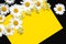 Spring summer pattern chamomile on yellow background and black desk