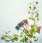 Spring or summer plant and flowers with three garden sign on light wooden background, top view,frame.